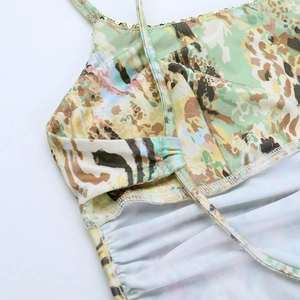 Macro detail of golden sequins on straps with green leopard print fabric texture