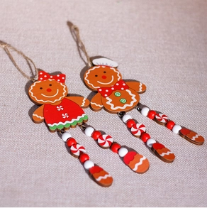 Detail of wooden gingerbread couple ornaments with bead legs for Christmas tree