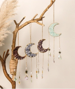 Detailed view of four crescent moon dream catchers with crystal stones and golden stars