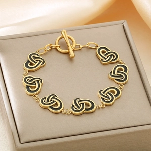Gold-plated stainless steel wrap bracelet with black enamel heart links and OT buckle