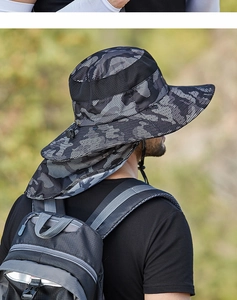 Detail of outdoor sun hat with camouflage pattern, neck flap and breathable mesh panel