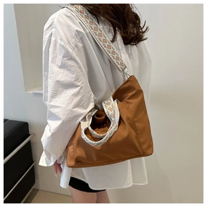 Brown nylon tote bag with ethnic pattern wide shoulder strap shown in a side-view pose