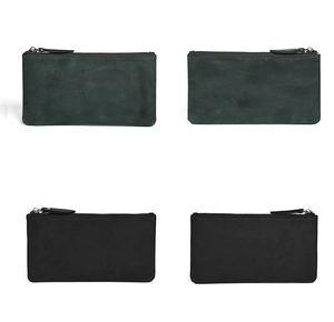 Detail view of slim leather wallets in black and dark green with textured matte finish