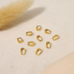 Macro shot of 10 golden U-shaped pendant bail connectors for DIY jewelry making