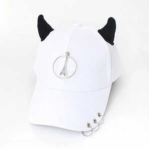 Detail of white baseball cap featuring black devil horns and silver metal rings decoration