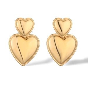 Polished gold-plated stainless steel double heart stud earrings on a white background