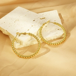 Elegant 18K gold plated twisted rope hoop earrings displayed on white mineral stones