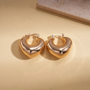 Detailed view of chunky 18K gold plated heart hoop earrings with a high-polished finish