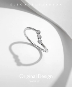 Macro view of minimalist s925 silver ring featuring three sparkling round moissanite stones