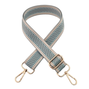 Detail view of woven herringbone shoulder strap in beige and grey blue with gold hooks