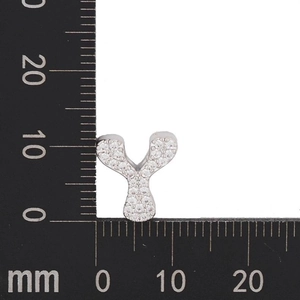 Macro detail of silver Y-letter pendant with zircon stones showing 10mm size scale