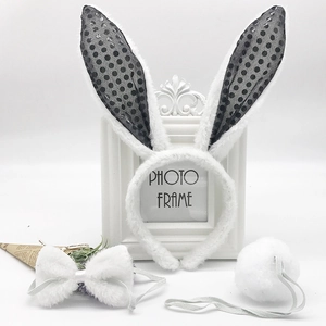 Detailed view of plush rabbit ear headband, bowtie, and tail costume accessories set