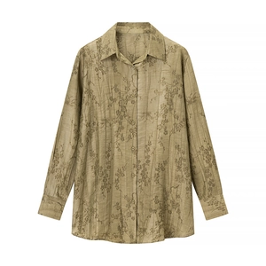 Detail of olive green jacquard textured fabric with floral print on long sleeve shirt