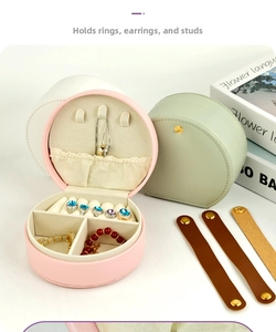 Detail of portable round jewelry box with compartments for rings earrings and necklaces