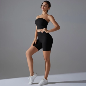 Detail of black high-waisted slimming yoga shorts and strapless sports tube top