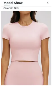 Detailed front view of pink ribbed yoga crop top with a slim fit and crew neck design