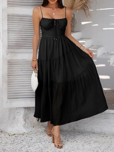 Detail of elegant black high-waisted tiered maxi dress with ruched drawstring chest design
