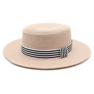 Detailed close-up of woven straw texture and striped ribbon on a flat top boater hat