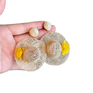 Raffia straw hat earrings with yellow floral detail for seaside summer vacation style
