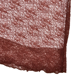 Macro shot of brown floral lace fabric with mesh structure and wavy scalloped edge