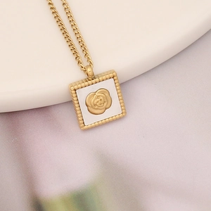 Detailed close-up of a golden square rose pendant necklace with beaded edges