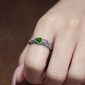 Macro detail of retro S925 silver ring with green gourd stone and filigree