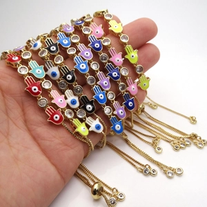 Hamsa hand evil eye bracelets in colorful enamel with adjustable gold slider chain