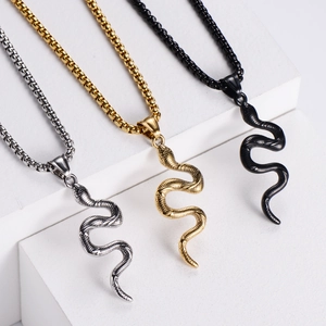Detailed view of cobra pendants with snake scale texture in gold silver and black