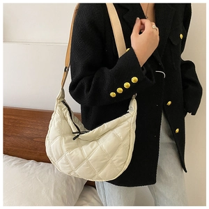 Quilted cream hobo bag with large diamond stitching and black zipper detail