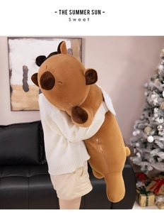 Close-up of extra large brown plush capybara pillow being held to show soft texture