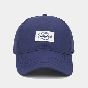 Close-up of navy quick-dry baseball cap with fabric patch and breathable laser-cut holes