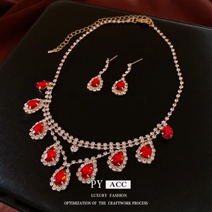 Luxury gold-plated necklace and earring set with red teardrop rhinestones and tassels