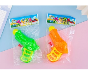 Close-up of vibrant orange and green mini water pistols in hanging tag packaging