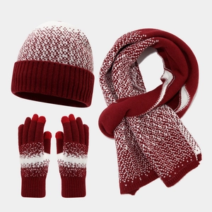 Close-up of winter knit set featuring touchscreen gloves and snowflake patterns