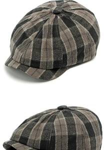 Detail of plaid newsboy cap showing grey checked pattern and stitched octagon panel design