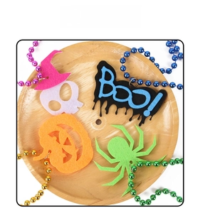 Detail of Halloween felt charms featuring pumpkin, skull and spider for festive decor