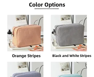 Detail view of striped seersucker makeup bags with zipper closure and side handles