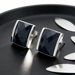 Macro shot of 18K gold plated square black crystal earrings with precision facet cuts