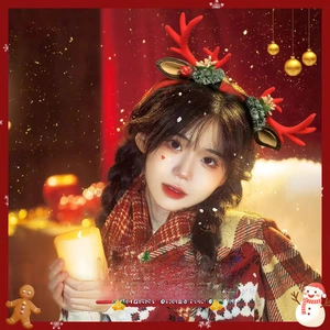 Detail of Christmas reindeer antler headband with bells and berries on a girl