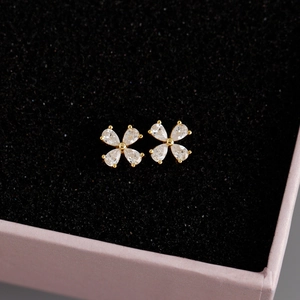 Macro shot of S925 silver flower stud earrings with pear-cut crystals in a gift box