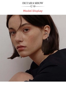 Close-up of irregular geometric silver ear cuff on model showing minimalist liquid design