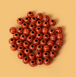 Macro detail of orange acrylic basketball beads with pre-drilled holes for DIY jewelry