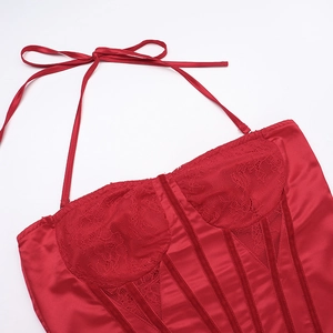 Detailed view of red satin and lace bustier top with delicate bow neck straps