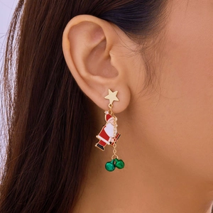 Detailed view of Christmas Santa earrings with green bells worn on an earlobe