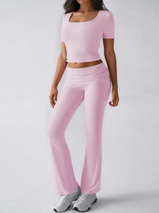 Pink Y2K crop top and flared pants set shown in a professional studio full-body shot
