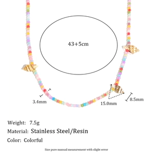Detail of colorful acrylic beads and shell charm on 18K gold plated stainless necklace
