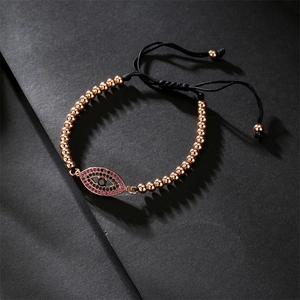 Detailed macro view of evil eye bracelet with rose gold beads and adjustable woven cord