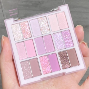 Macro shot of a 16-color eyeshadow palette featuring matte and shimmering pink tones