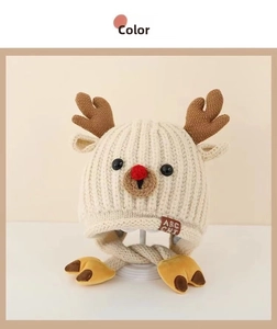 Close-up of beige knit baby hat with reindeer antlers and soft fleece lining details