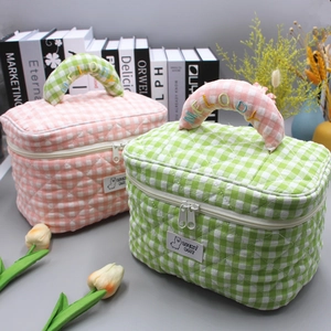 Quilted plaid makeup bags in pink and green with Melody embroidery and handles